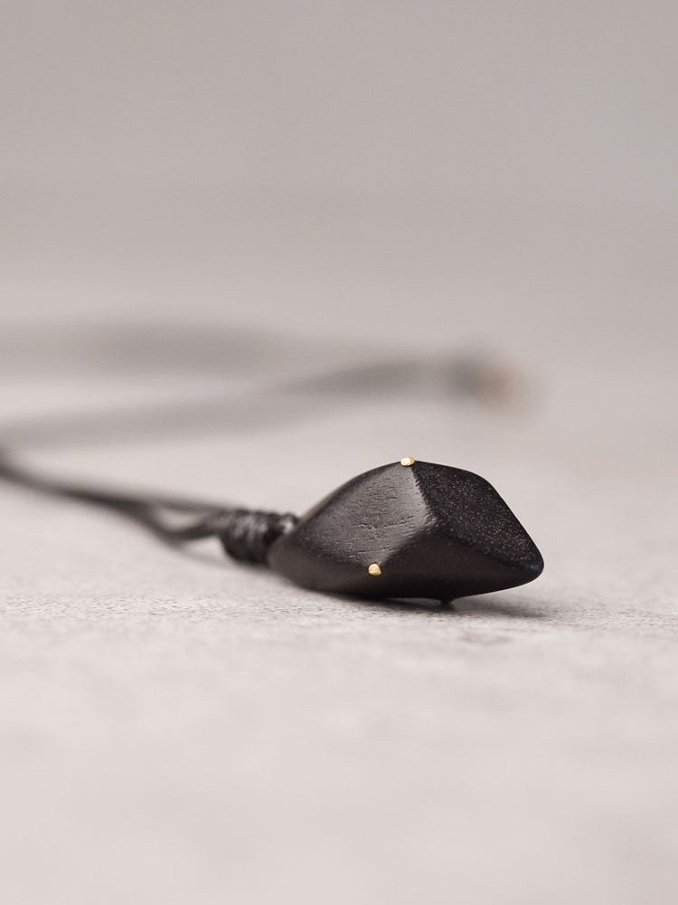 Hand-Polished Ebony Spear Pendant with Brass Inlays