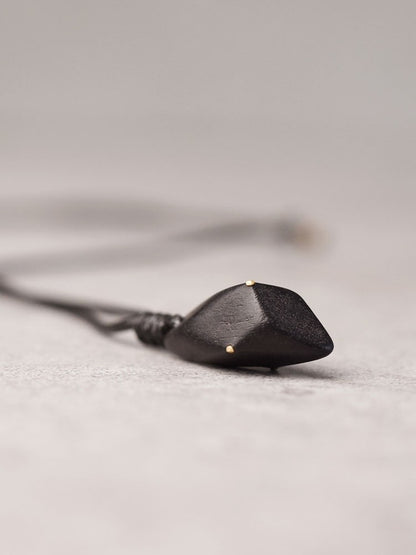 Hand-Polished Ebony Spear Pendant with Brass Inlays