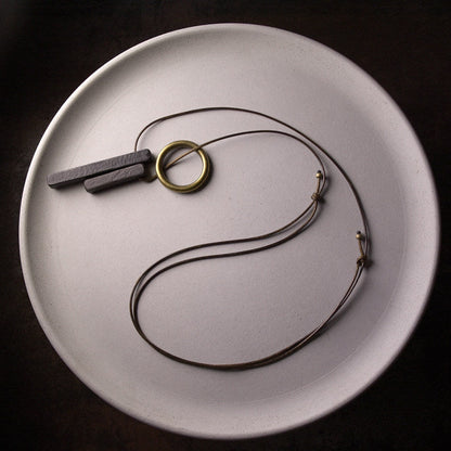 Hand-Chiseled Ebony "Orb" Pendant with Brass Filament