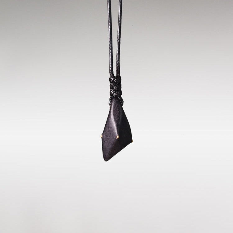 Hand-Polished Ebony Spear Pendant with Brass Inlays