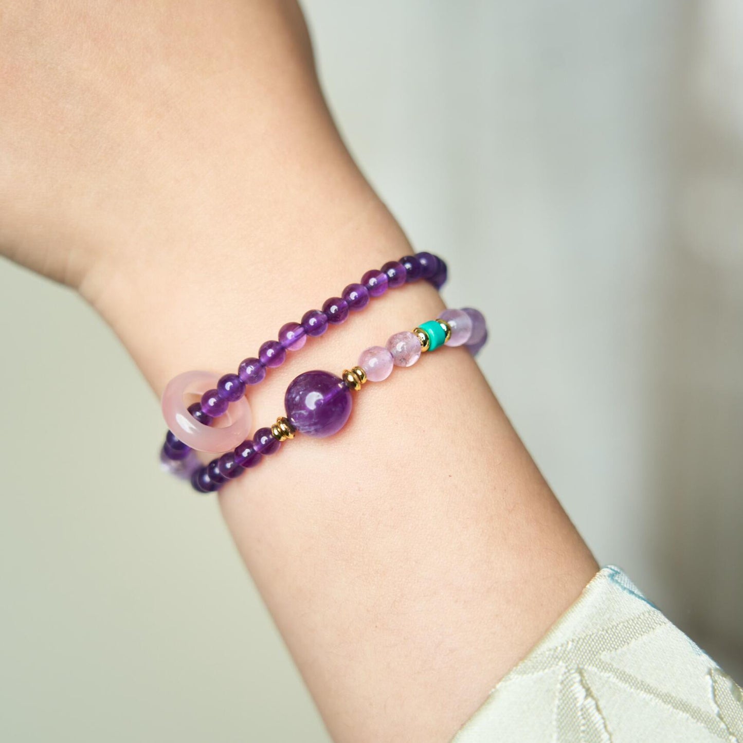 Side view of 2-wrap Amethyst healing crystal bracelet showing mixed bead sizes and gold spacers