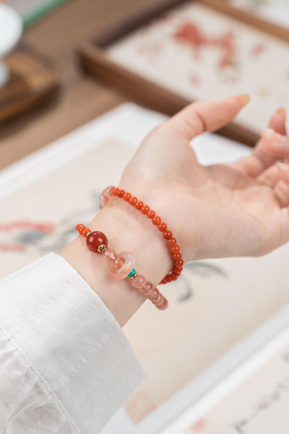 Close up of wrist showing the translucent jelly agate beads and small red agate donut charm