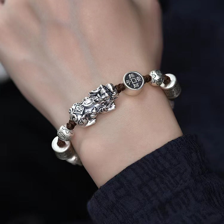 Man wearing vintage style Pixiu feng shui bracelet with silver-tone copper charms