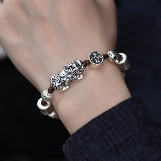 Man wearing vintage style Pixiu feng shui bracelet with silver-tone copper charms